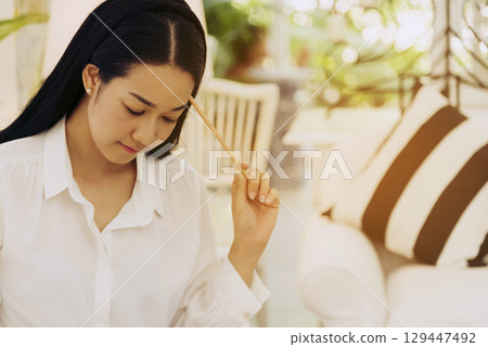 Desperate Asian woman stress headache depressed from startup small business at home office. Failure business woman work at home office. Online seller entrepreneur has problem delivery unhappy job 129447492