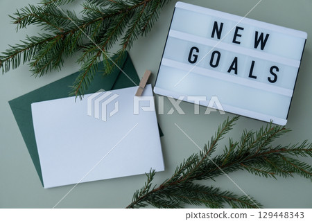 Motivational saying NEW GOALS with empty paper envelope note Copy space Christmas mockup for lettering art drawing. Aims setting concept. Strategy for self development improvement. Inspirational 129448343