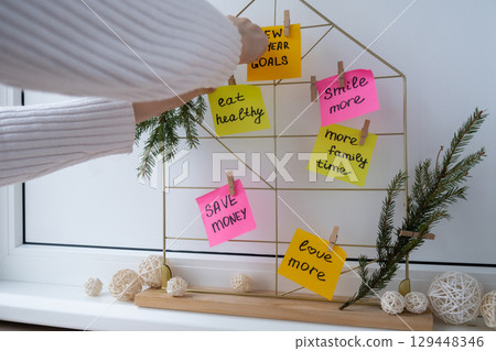 Woman creating dream board promises and aims. Preparation for new year new life new me. Visualizing wish list for 2025. Dreams plan action resolutions for coming year. Inspirational self improvement Woman creating dream board promises and aims. Preparation for new year new life new me. Visualizing wish list for 2025. Dreams plan action resolutions for coming year. Inspirational self improvement 129448346