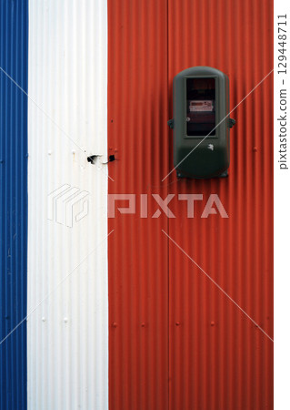 Electric meter installed on a tin wall Electric meter installed on a tin wall 129448711
