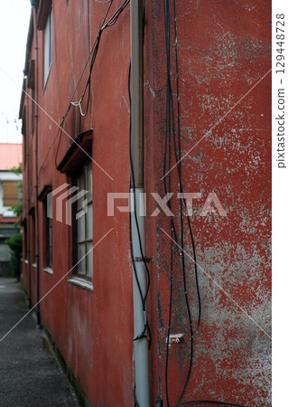 Red walls of an old wooden apartment building Red walls of an old wooden apartment building 129448728