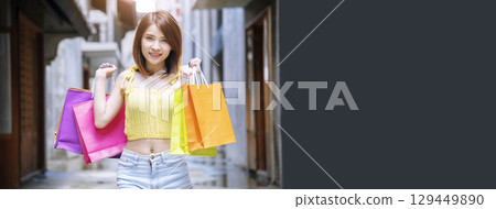 Banner Shopping bags of women crazy shopaholic person at fashion mall. Web Banner Woman love online shopping website holding shopping bags in hands with copy space. digital marketing happy lifestyle 129449890