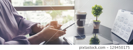 Banner Businesswoman reading financial graph charts business info with computer laptop. Panorama Women hands using laptop on office desk. Hands of business woman working office with copy space 129450175
