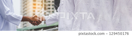 Banner Arab Businessman Muslim dress shaking hands together. Panorama Muslim Men Teamwork business partner handshake teams Partnership. multiracial UAE diversity  people trust honesty with copy space 129450176