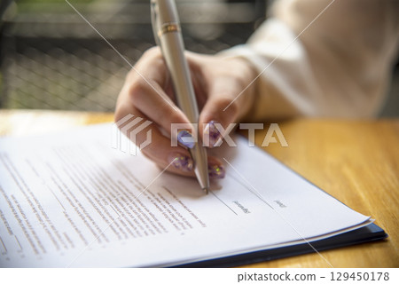 Businesswoman hands note meeting document in conference room. Woman Hands writing planning on notebook. Female hand holding pencil write on diary sketchbook. Business Planning Concept. 129450178