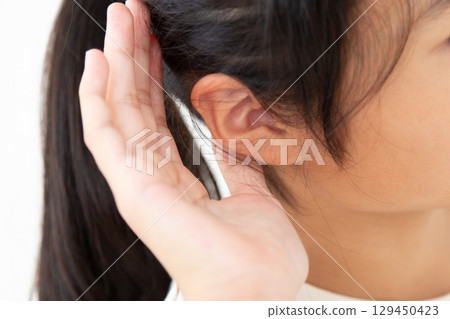 A middle school girl listening intently 129450423