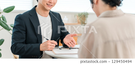 Young Asian businessman meeting, counseling and hearing with female client at negotiation table 129450494