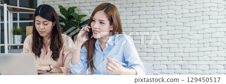 Banner Happy success business woman partner meeting working together in company office. Panoramic picture of Meeting Executive Asian business woman office desk with fist arm raised executive teamwork 129450517
