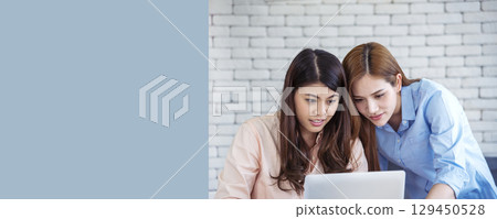 Banner Happy success business woman partner meeting working together in company office. Panoramic picture of Meeting Executive Asian business woman office desk with fist arm raised executive teamwork Banner Happy success business woman partner meeting working together in company office. Panoramic picture of Meeting Executive Asian business woman office desk with fist arm raised executive teamwork 129450528