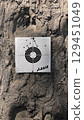Shooting target on tree trunk with bullet holes. Outdoor shooting range with paper target for airgun practice. Rustic texture background. Close-up view for sport and accuracy themes. 129451049