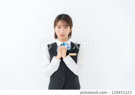 Young woman in uniform, business, worried 129451223