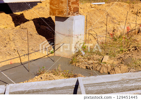 Concrete is being poured for foundation of new building at construction site 129451445