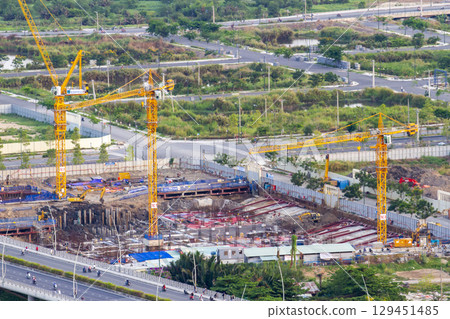 Aerial View Of A Busy Construction Site With Multiple Tower Cranes Working. 129451485