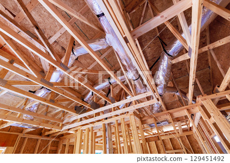 Construction site roof frame intricate wooden framework, ventilation ducts for new residential works 129451492