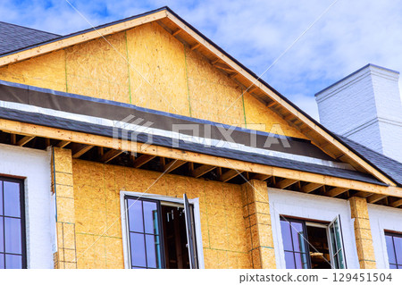 New construction features wooden framing open windows, reflecting progress under works day 129451504