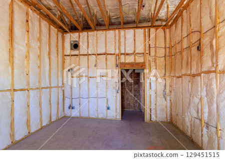An unfinished room insulation material set for drywall installation, ready for further construction steps. 129451515