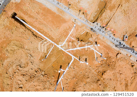 Complex network of PVC pipes laid out on foundation area construction site preparation for future building projects. 129451520