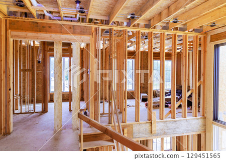 Construction site wooden framework in residential house with large windows, an open layout. 129451565
