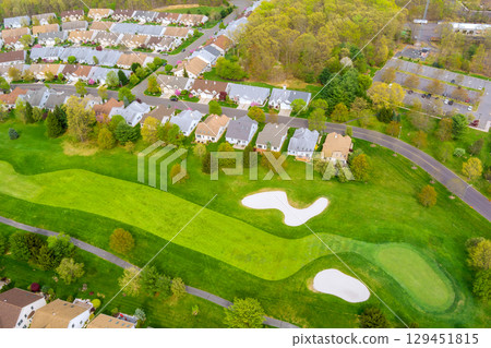Residential neighborhood landscape showing houses along curved roads with mature trees well maintained spaces in Middlesex County, New Jersey. Residential neighborhood landscape showing houses along curved roads with mature trees well maintained spaces in Middlesex County, New Jersey. 129451815