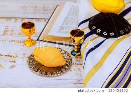 Traditional celebrating Jewish holiday of Sukkot with etrog fruit for Jewish holiday ceremonial prayer book. Traditional celebrating Jewish holiday of Sukkot with etrog fruit for Jewish holiday ceremonial prayer book. 129451832