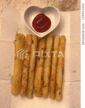 Crispy potato cheese sticks with a golden exterior, filled with gooey, melted cheese. A savory and indulgent snack perfect for dipping or enjoying on their own. 129451920