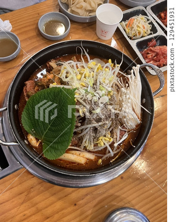 Rich and hearty gamjatang, a Korean pork bone soup with tender meat, potatoes, and vegetables in a spicy, flavorful broth. A comforting dish perfect for a satisfying meal. Rich and hearty gamjatang, a Korean pork bone soup with tender meat, potatoes, and vegetables in a spicy, flavorful broth. A comforting dish perfect for a satisfying meal. 129451931