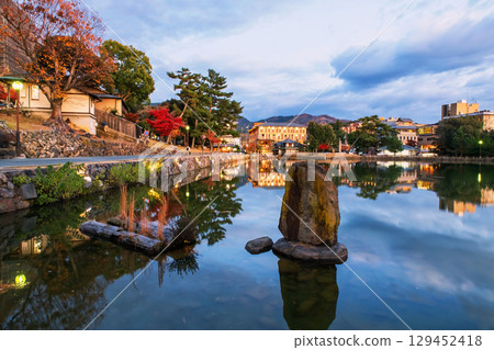 Stone inscription statue over Sarusawaike pond in autumn, Nara Stone inscription statue over Sarusawaike pond in autumn, Nara 129452418