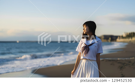 High school girls walking along the beach at sunset 129452530