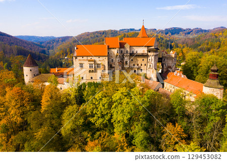 Medieval castle of Pernstein on a hill in the forest. South Moravian region. 129453082