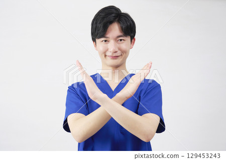 Doctor, nurse, dentist, caregiver male cross gesture white background 129453243