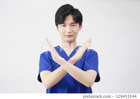 Doctor, nurse, dentist, caregiver male cross gesture white background Doctor, nurse, dentist, caregiver male cross gesture white background 129453244