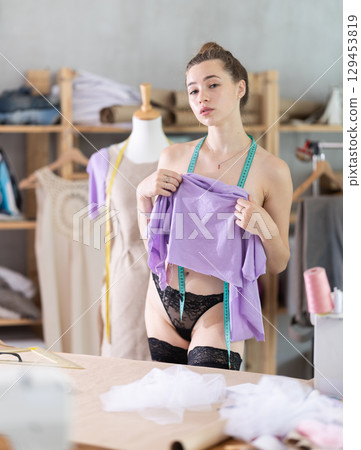 Young topless woman covers herself with fabric 129453819