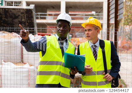 Two architects discussing construction project Two architects discussing construction project 129454417