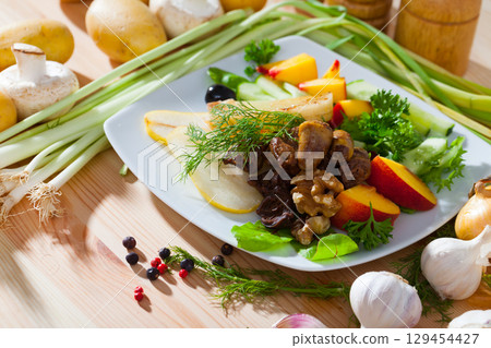 Salad with chicken hearts, peaches, pears 129454427