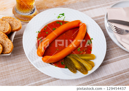 Pair of Viennese sausages with saft goulash on plate 129454437