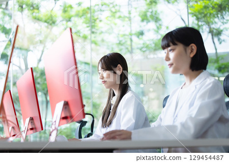 A young lady in a white suit 129454487