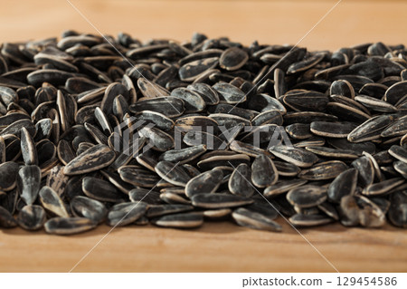 Sunflower seeds on wooden surface 129454586