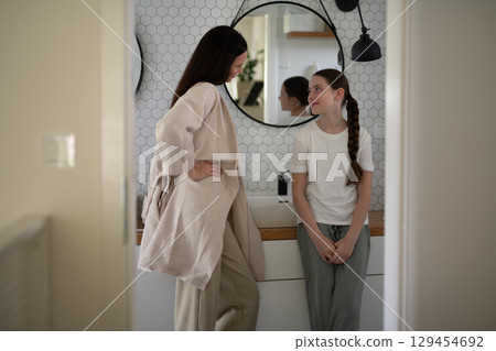 mother and daughter sharing a moment in the bathroom mother and daughter sharing a moment in the bathroom 129454692