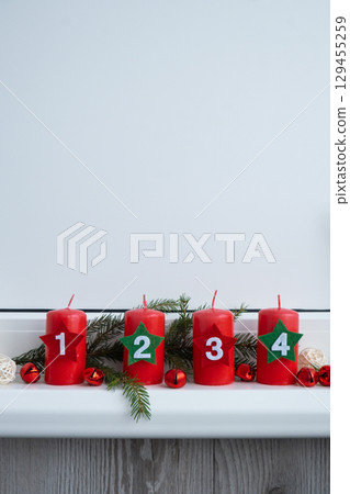 Traditional four advent weeks before Christmas holidays. Red candles with numbers and plastic free decoration. Copy space greeting card mock up template. Winter cozy Traditional four advent weeks before Christmas holidays. Red candles with numbers and plastic free decoration. Copy space greeting card mock up template. Winter cozy 129455259