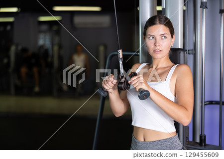 Young woman training with straps in gym Young woman training with straps in gym 129455609