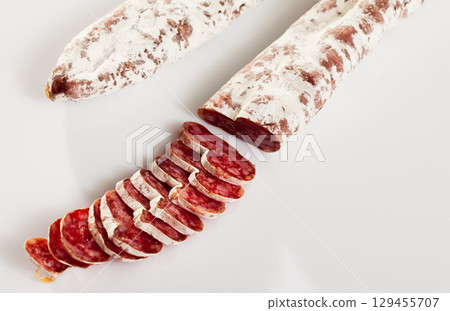 Sliced Catalan dry cured sausage Fuet 129455707