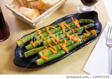 Grilled asparagus with romesco 129455728
