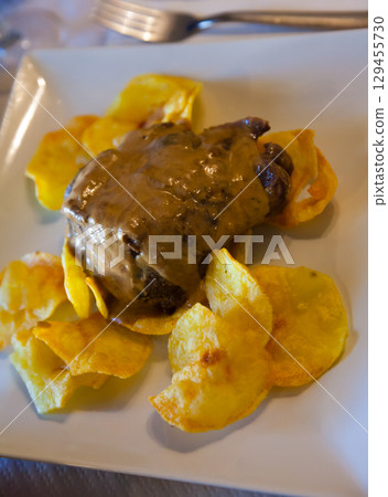 Pork cheeks in red wine 129455730