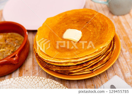 Thin pancakes with butter and machanka of meat with vegetables and mushrooms Thin pancakes with butter and machanka of meat with vegetables and mushrooms 129455785