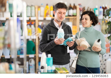 Couple man and woman choosing shampoo or shower gel and body washcloth Couple man and woman choosing shampoo or shower gel and body washcloth 129456063
