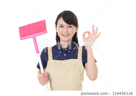 A woman with a broom 129456126