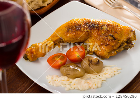 Roasted chicken thighs with baked onions and sauce. Roasted chicken thighs with baked onions and sauce. 129456286