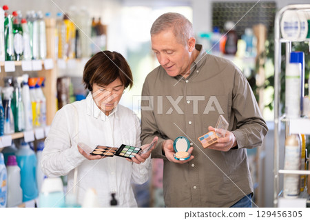 Couple man and woman choosing cosmetics in store 129456305
