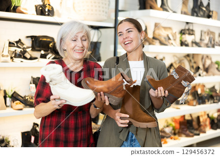 Two women are shopping in shoe store 129456372