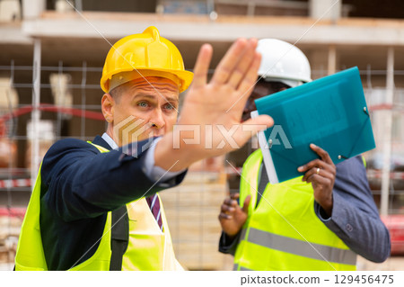 Engineers hiding their faces in front of camera Engineers hiding their faces in front of camera 129456475